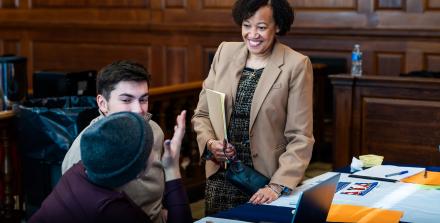 Three friendly people talking in a courtroom